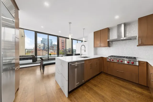 a view of a balcony with couches and wooden floor