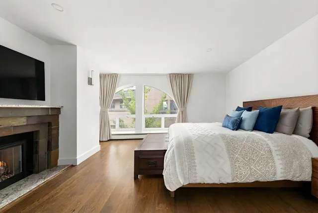 a kitchen with stainless steel appliances granite countertop a stove and a wooden floors