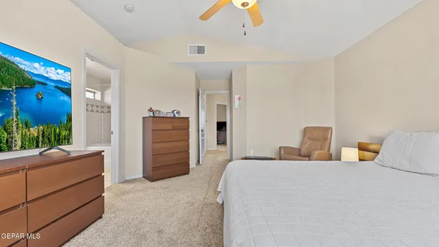 a bedroom with a bed and a dresser