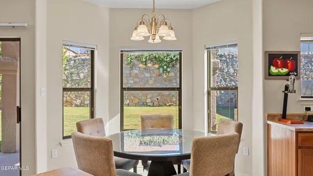 a view of a dining room with furniture a chandelier and wooden floor