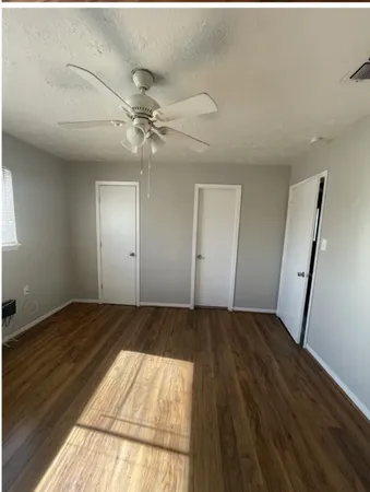 wooden floor in an empty room with a fireplace