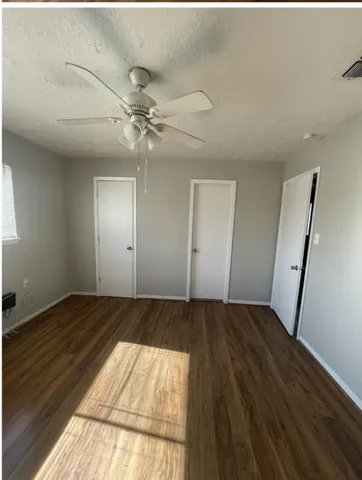 wooden floor in an empty room with a fireplace