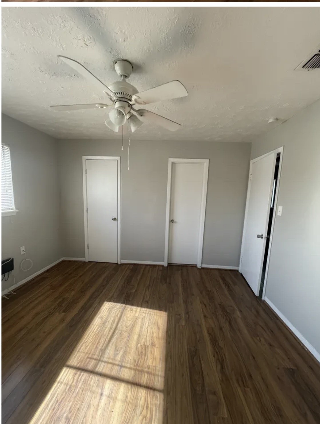 1014 East 23rd Street, Unit 3 Bryan, TX 77803 - Photo 5 of 8 wooden floor in an empty room with a fireplace