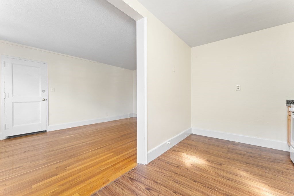 11 Victory Road, Unit 32 Boston, MA 02122 - Photo 13 of 16 a view of an empty room with wooden floor