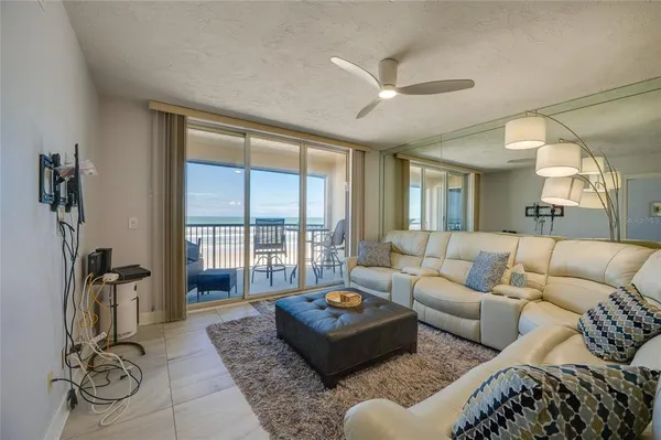 a living room with furniture and a floor to ceiling window