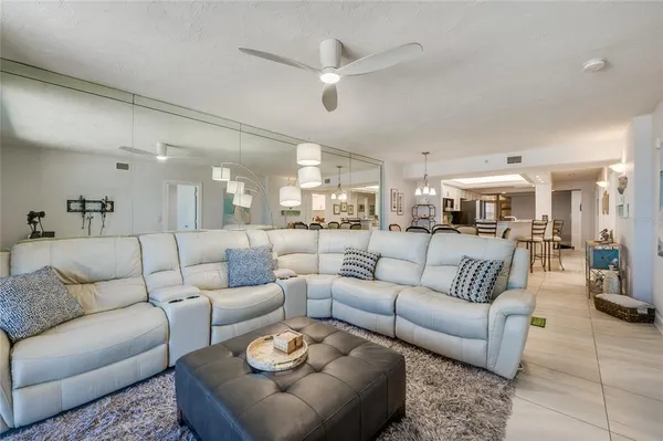 a view of a livingroom with a ceiling fan and window