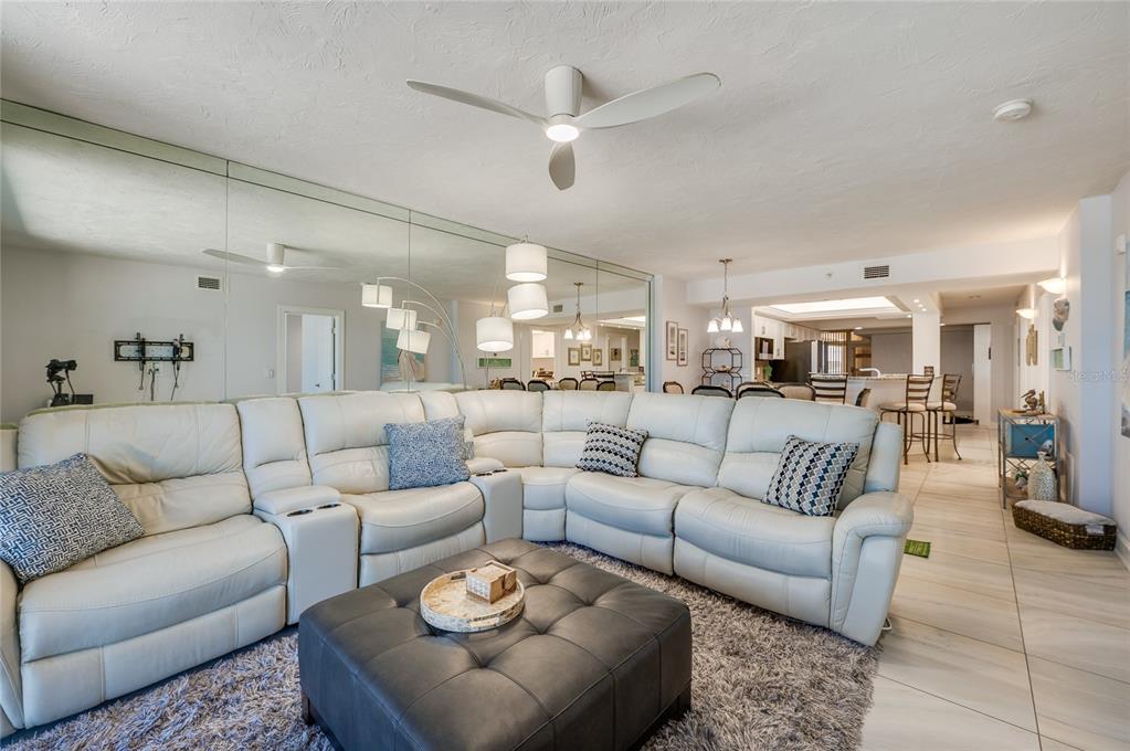 4575 South Atlantic Avenue, Unit 6304 Ponce Inlet, FL 32127 - Photo 17 of 37 a living room with furniture kitchen view and a chandelier