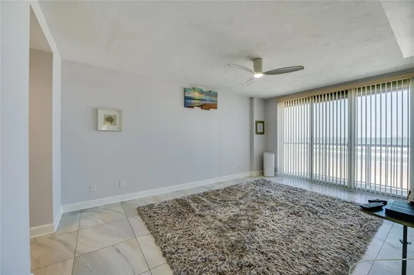 a living room with a flat screen tv and a rug