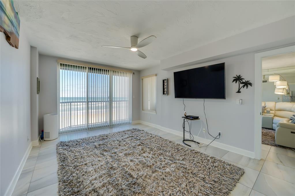 4575 South Atlantic Avenue, Unit 6304 Ponce Inlet, FL 32127 - Photo 19 of 37 a living room with a flat screen tv and a rug