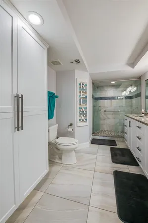a bathroom with a sink a large mirror and a shower
