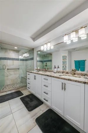 a bathroom with a glass shower door