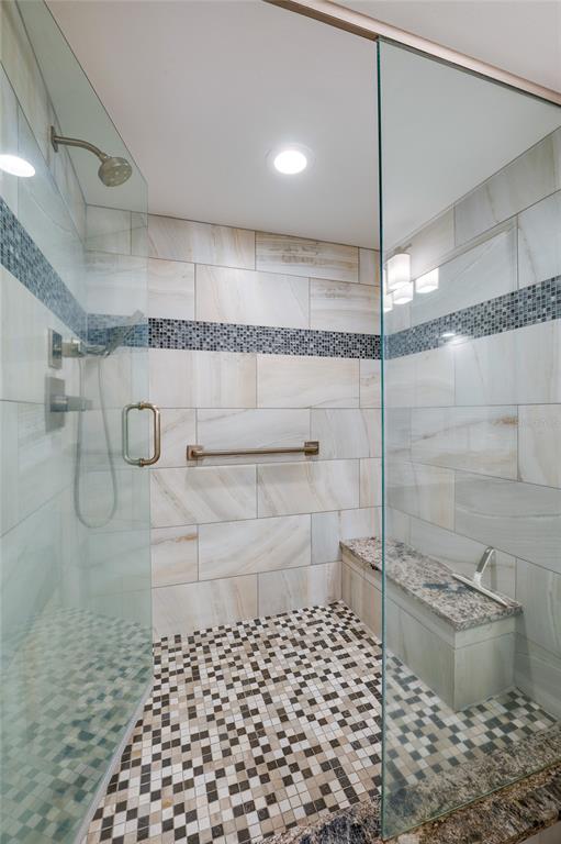 4575 South Atlantic Avenue, Unit 6304 Ponce Inlet, FL 32127 - Photo 24 of 37 a bathroom with a glass shower door