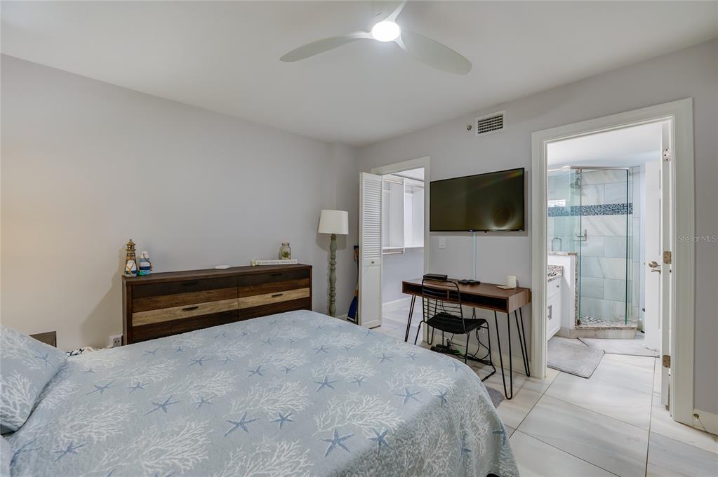 4575 South Atlantic Avenue, Unit 6304 Ponce Inlet, FL 32127 - Photo 26 of 37 a bedroom with a bed and a flat screen tv