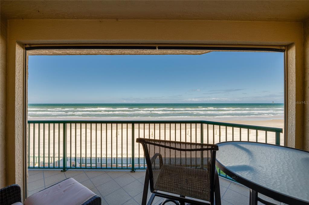 4575 South Atlantic Avenue, Unit 6304 Ponce Inlet, FL 32127 - Photo 35 of 37 a view of a chair and table in the back