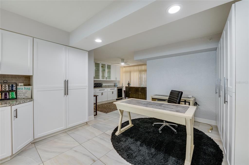 4575 South Atlantic Avenue, Unit 6304 Ponce Inlet, FL 32127 - Photo 4 of 37 a kitchen with a table chairs refrigerator and cabinets
