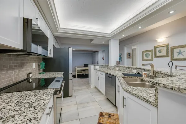 a kitchen with stainless steel appliances a refrigerator sink and stove