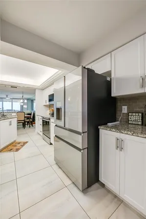 a kitchen with stainless steel appliances granite countertop a refrigerator and a sink