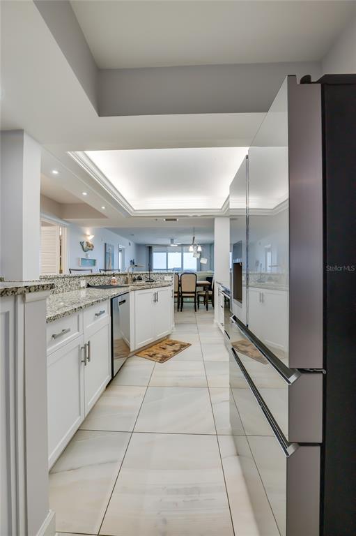 4575 South Atlantic Avenue, Unit 6304 Ponce Inlet, FL 32127 - Photo 10 of 37 a kitchen with stainless steel appliances granite countertop a refrigerator and a sink