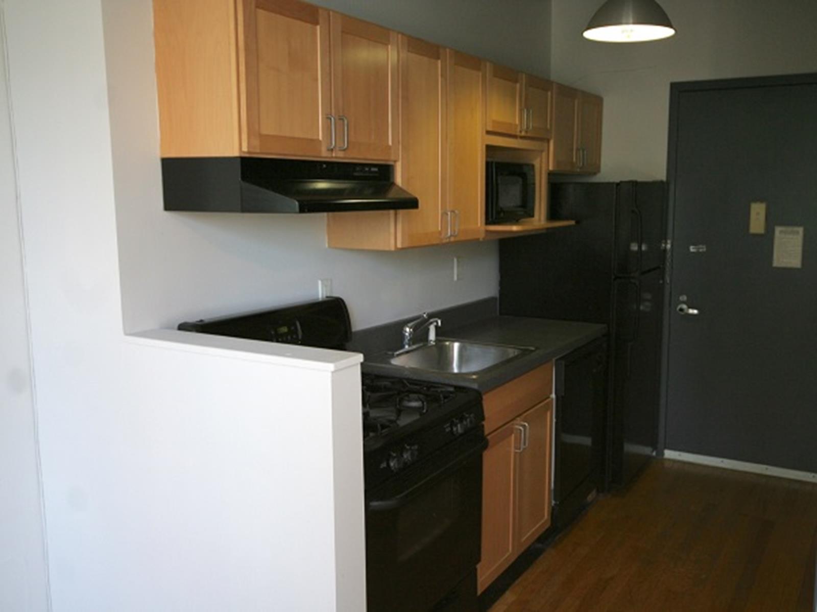 47-45 Vernon Boulevard, Unit 3C Queens, NY 11101 - Photo 2 of 6 a kitchen with a sink and a refrigerator