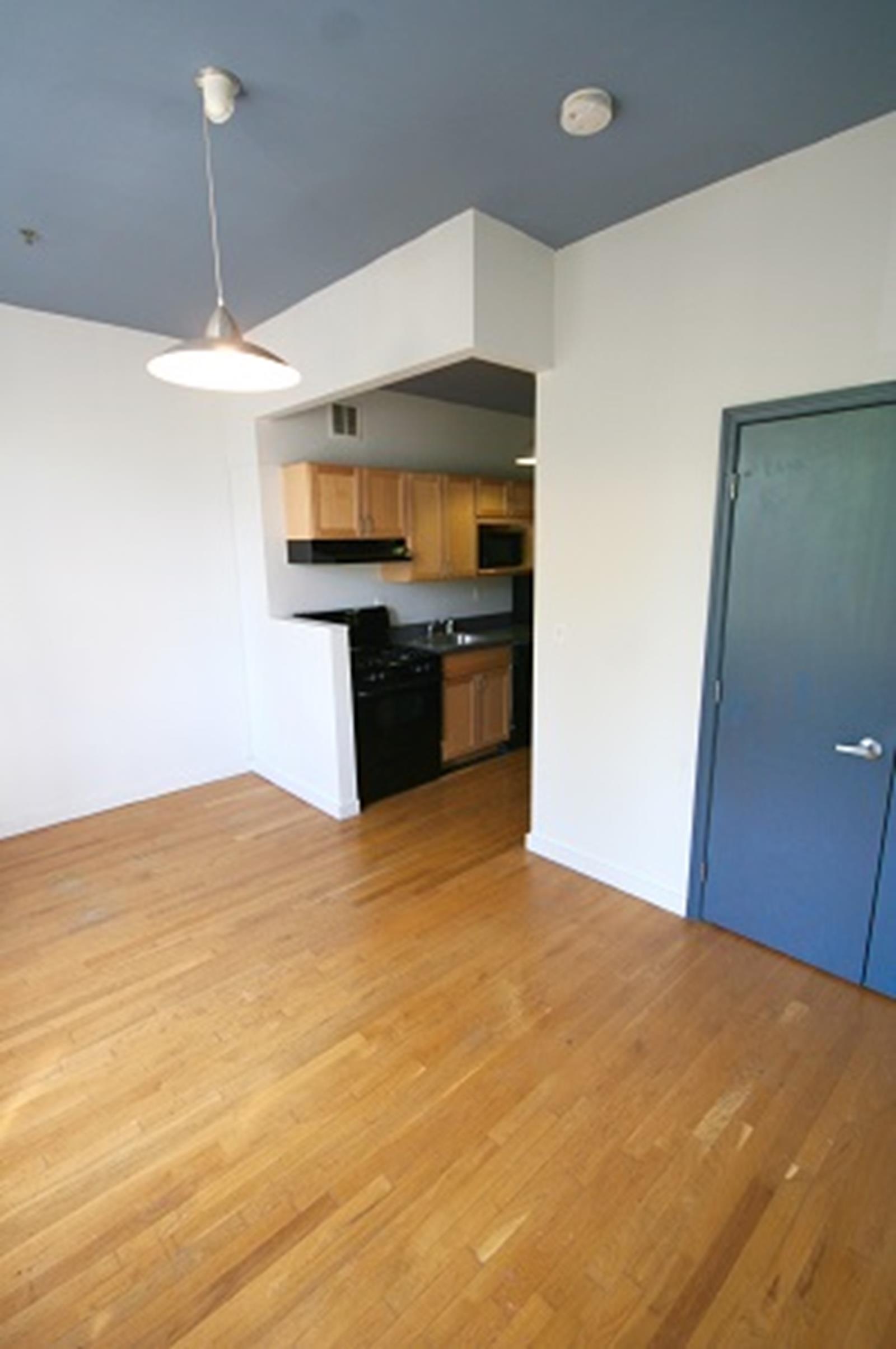 47-45 Vernon Boulevard, Unit 3C Queens, NY 11101 - Photo 3 of 6 a kitchen with stainless steel appliances granite countertop a sink and cabinets