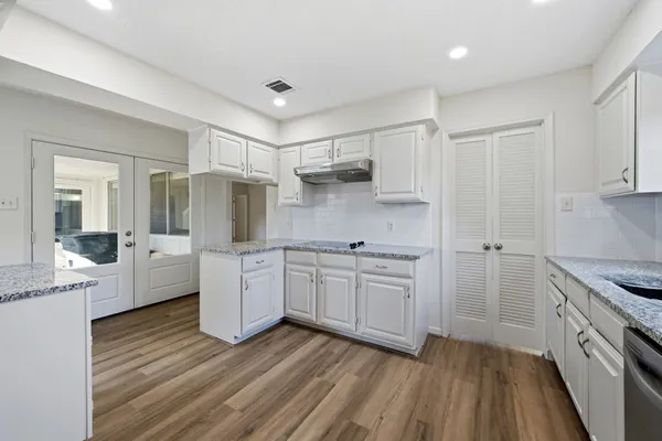 a kitchen with cabinets oven and a dishwasher