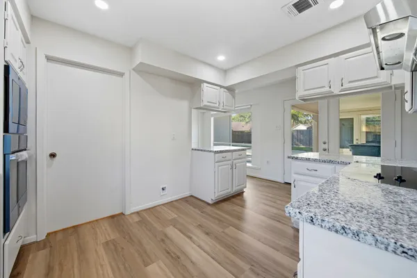 a large space with a lot of kitchen island and wooden floor