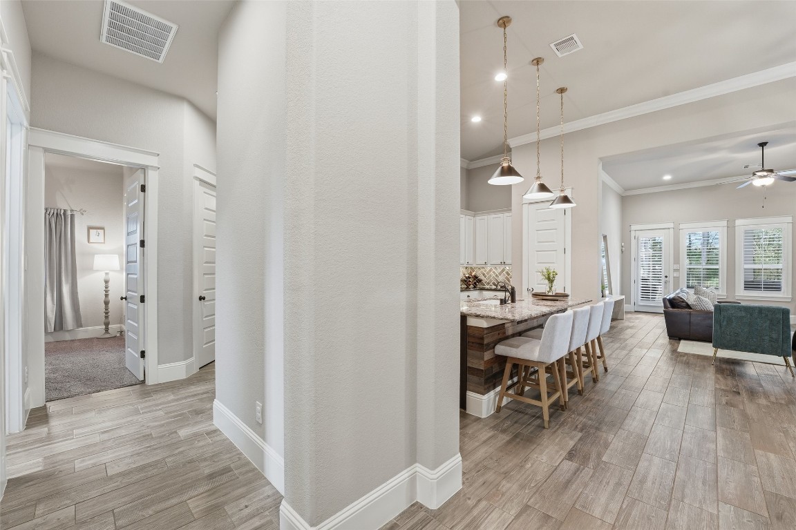 2172 Rope Maker Road Conroe, TX 77384 - Photo 12 of 50 Hallway with beautiful flooring that flows through the house leeads to additional living spaces.