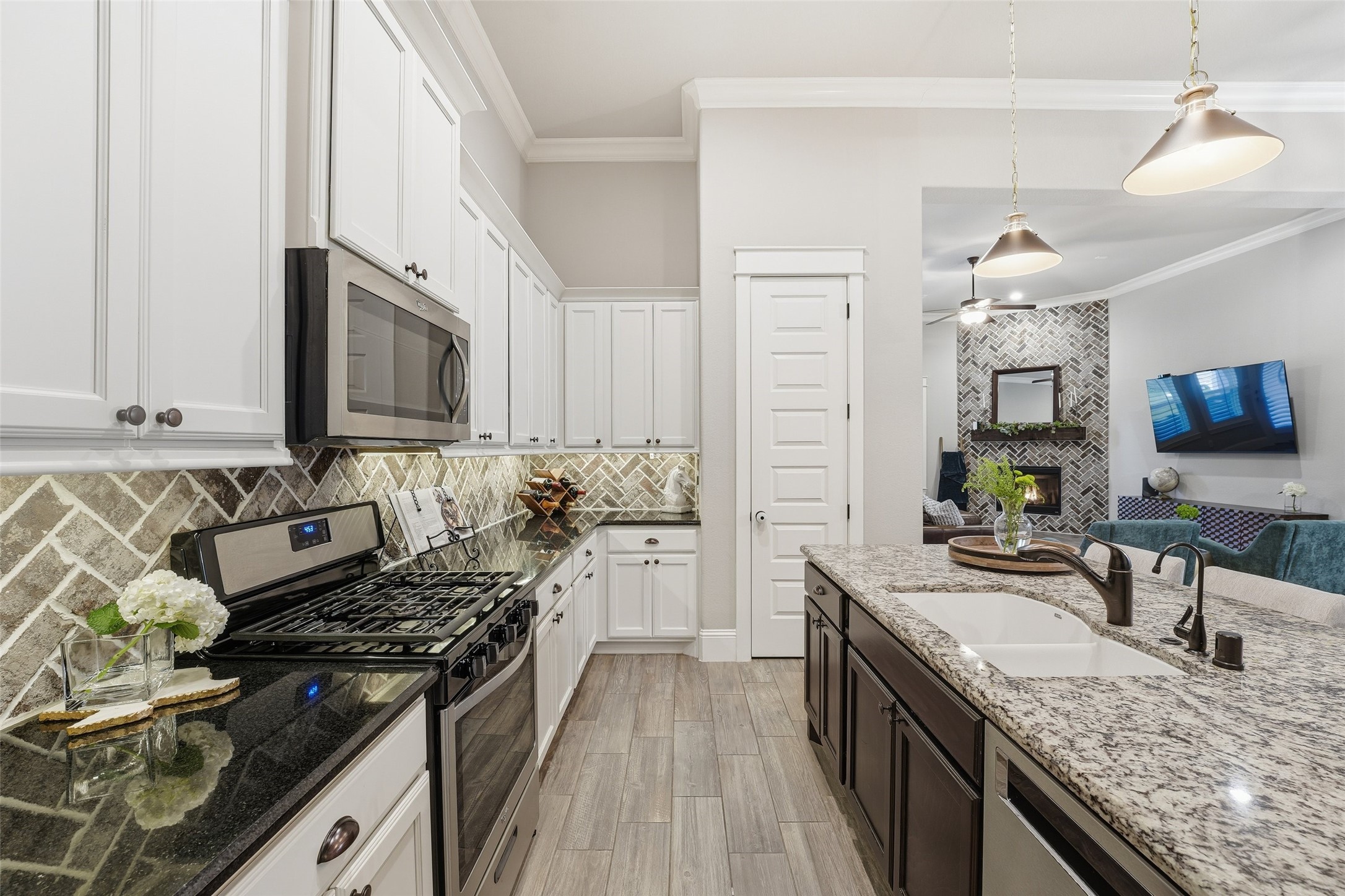 2172 Rope Maker Road Conroe, TX 77384 - Photo 14 of 50 a kitchen with stainless steel appliances granite countertop a stove and a sink