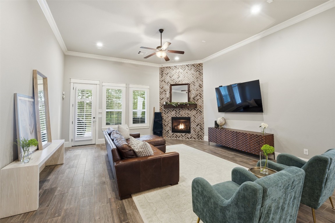 2172 Rope Maker Road Conroe, TX 77384 - Photo 17 of 50 Charming living room has 12 ft. ceilings, recessed lighting, beautiful plantation shutters and warm and welcoming fireplace. Windows plenty of natural light add to this beautiful space. The view of the nature reserve in the back creates the perfect space!