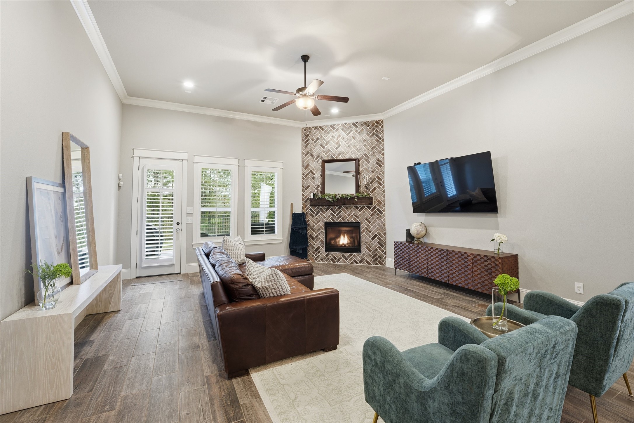 2172 Rope Maker Road Conroe, TX 77384 - Photo 17 of 50 a living room with furniture a fireplace and a flat screen tv