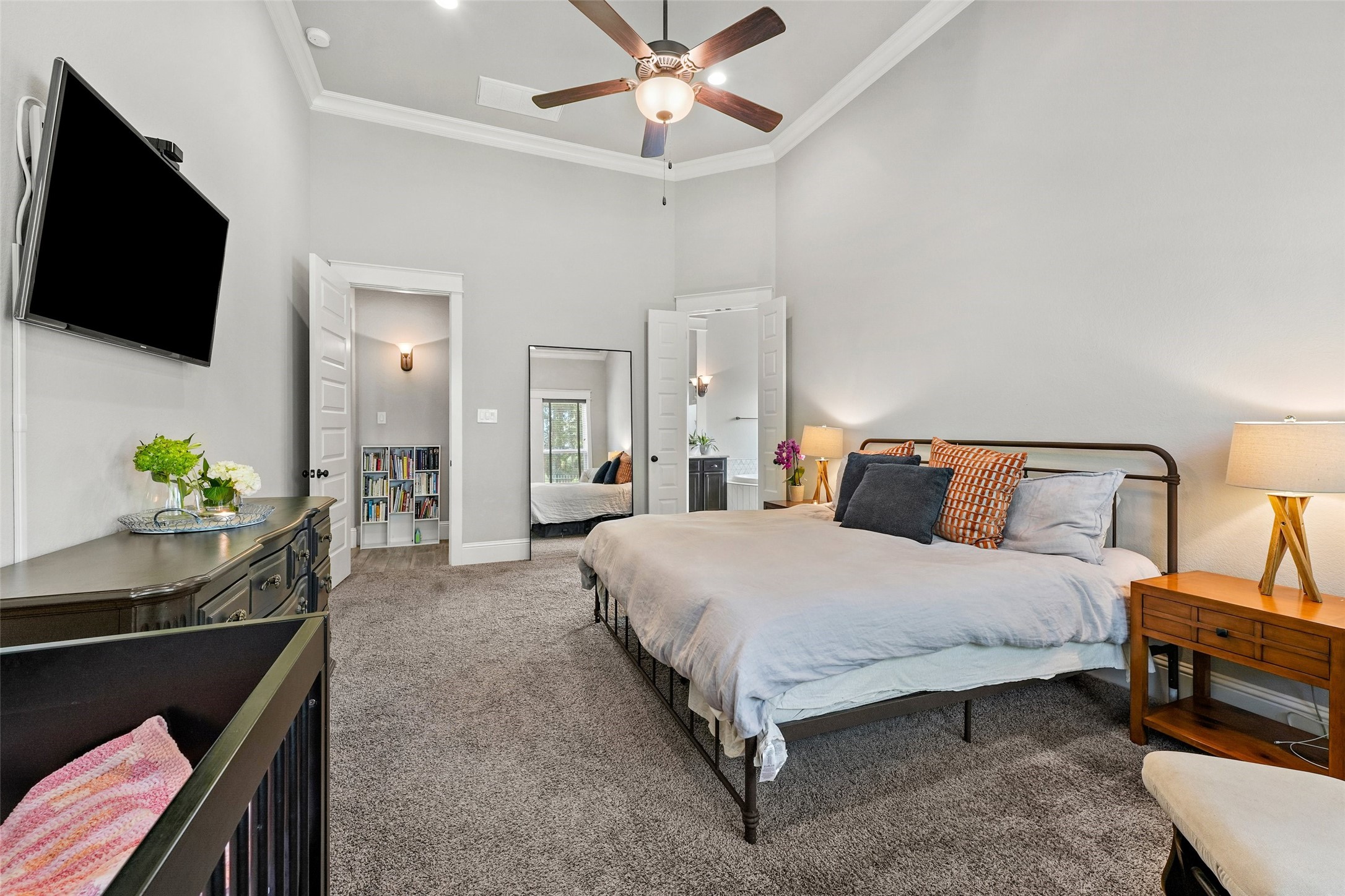 2172 Rope Maker Road Conroe, TX 77384 - Photo 20 of 50 a spacious bedroom with a bed and a flat screen tv