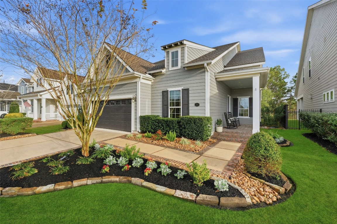 2172 Rope Maker Road Conroe, TX 77384 - Photo 2 of 50 This charming home features a modern exterior with an oversized garage and well-maintained landscaping. The inviting front yard includes a tree and manicured bushes, creating excellent curb appeal.