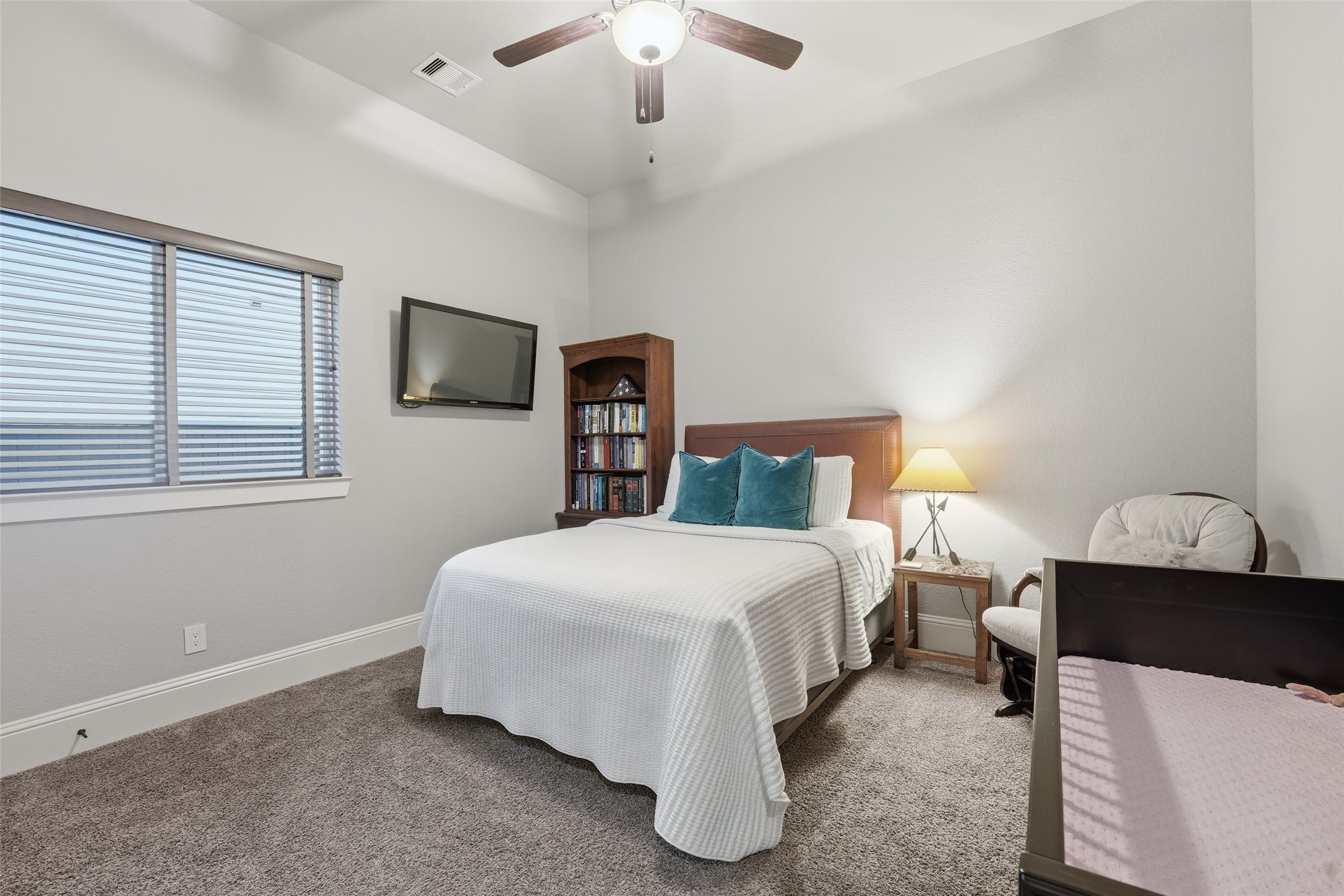 2172 Rope Maker Road Conroe, TX 77384 - Photo 31 of 50 a bedroom with a bed and a chandelier