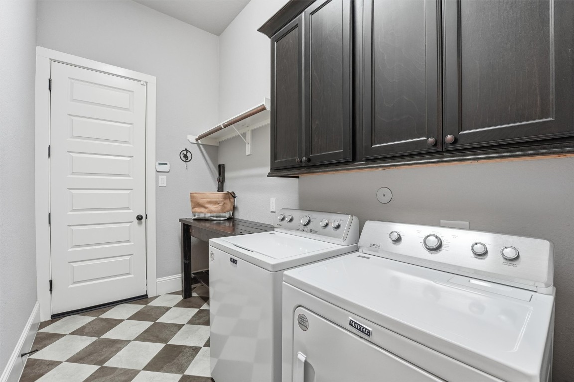2172 Rope Maker Road Conroe, TX 77384 - Photo 33 of 50 Designer touches in this very spacious laundry room. Checkered tile floors, cabinets, hanging space for drying clothes, and room for more storage!