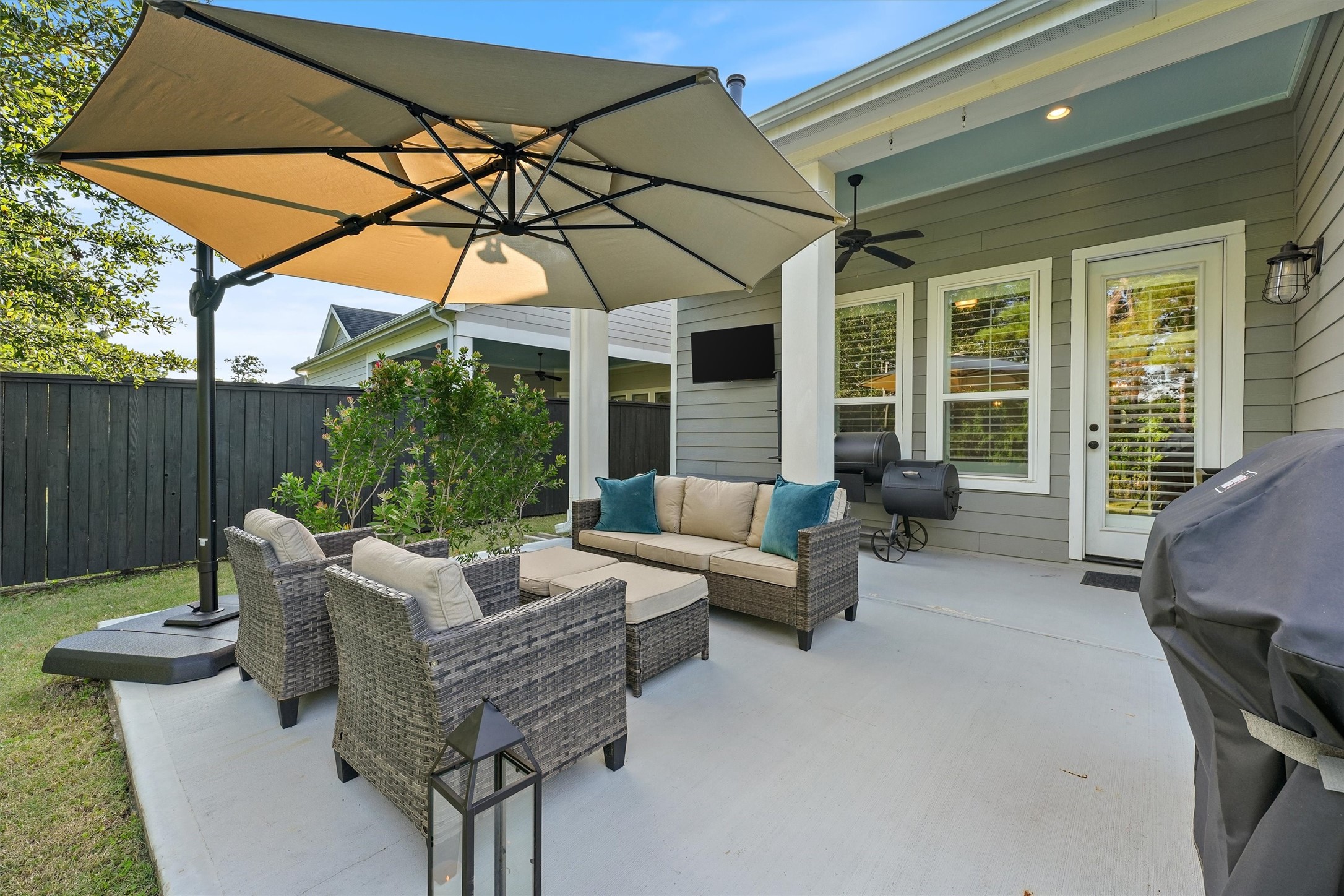 2172 Rope Maker Road Conroe, TX 77384 - Photo 35 of 50 a view of a patio with couches and chairs under an umbrella