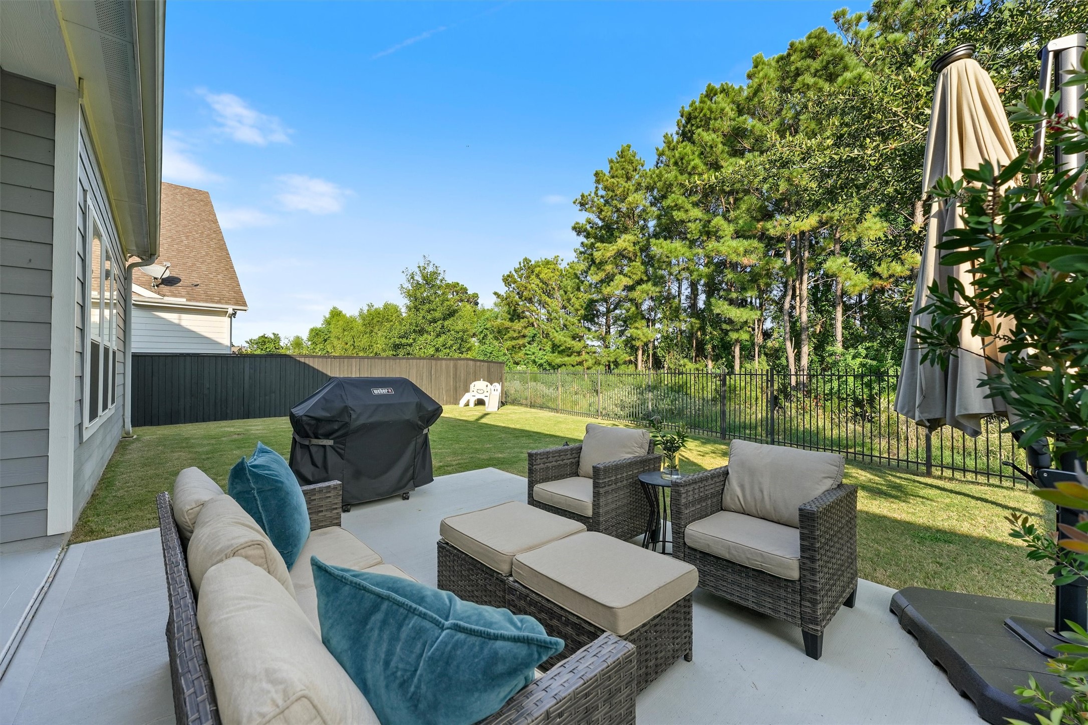 2172 Rope Maker Road Conroe, TX 77384 - Photo 36 of 50 a view of a patio with couches and a fire pit