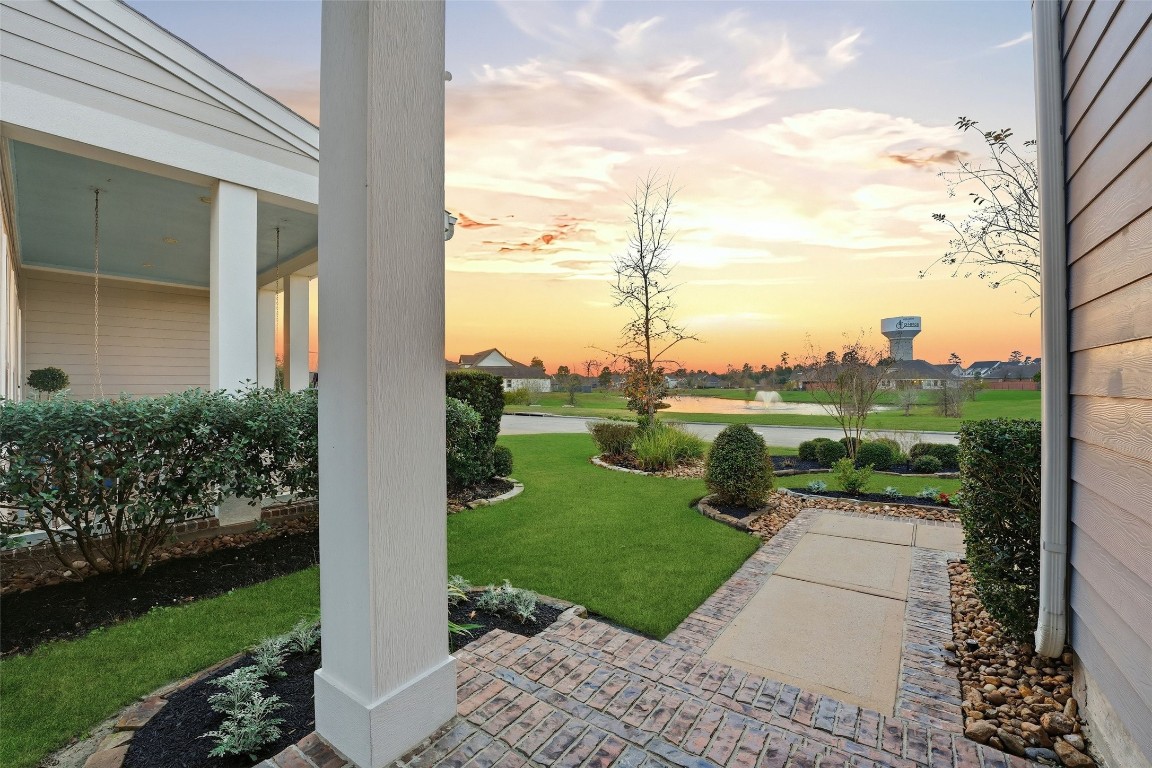 2172 Rope Maker Road Conroe, TX 77384 - Photo 5 of 50 This is the actual sunset view from the porch overlooking a beautifully landscaped garden and lake with fountain! Enjoy this view every day!