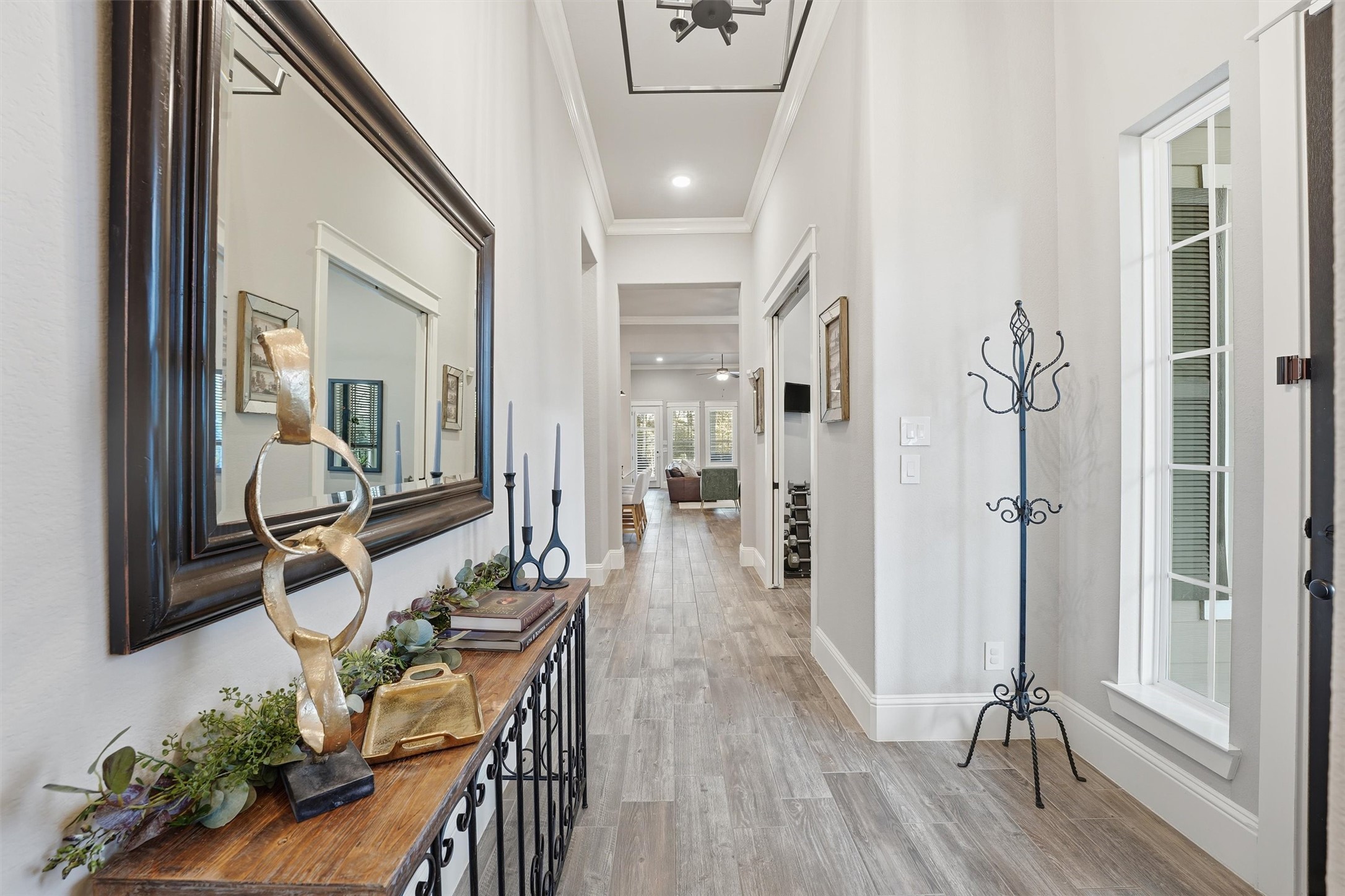 2172 Rope Maker Road Conroe, TX 77384 - Photo 7 of 50 a hallway with wooden floor and furniture