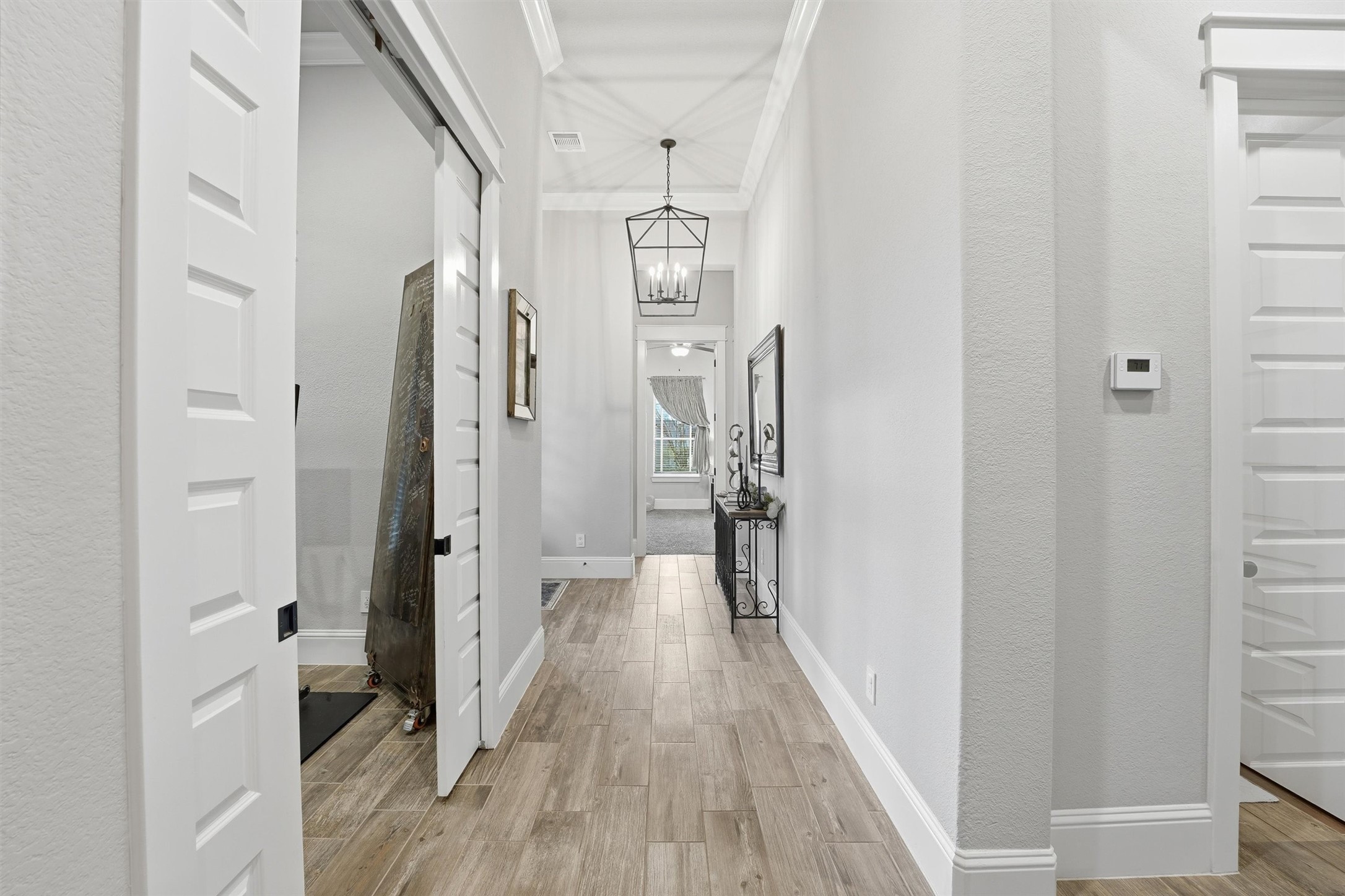 2172 Rope Maker Road Conroe, TX 77384 - Photo 10 of 50 a view of a hallway with wooden floor and staircase