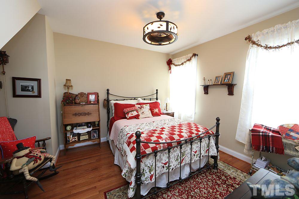 521 Competition Road Raleigh, NC 27603 - Photo 13 of 25 Second bedroom on main floor with full bath just outside the door in hall. New hardwood floors in 2017. This home is loved by owners and it shows.