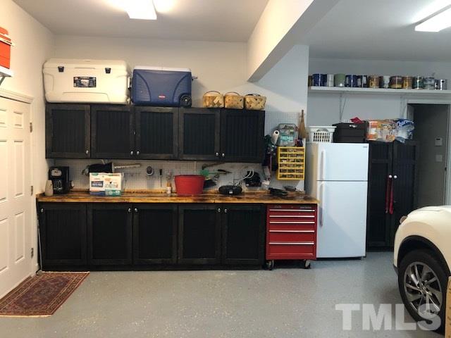 521 Competition Road Raleigh, NC 27603 - Photo 19 of 25 This two bay garage has built ins galore with custom top and base cabinets, countertop, shelving for paint, enclosed cabinet for two sets of golf clubs. Let's play golf!