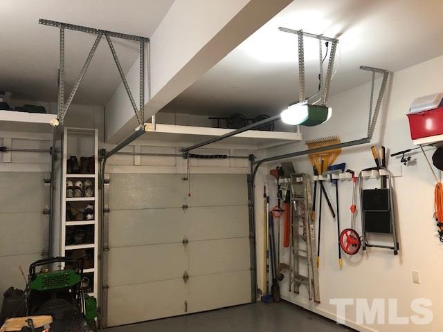 521 Competition Road Raleigh, NC 27603 - Photo 20 of 25 Two bay garage with custom shelving between bays for golf shoes, yard shoes, etc. storage. Storage above each garage door has also been installed. Loads of storage and organization here.