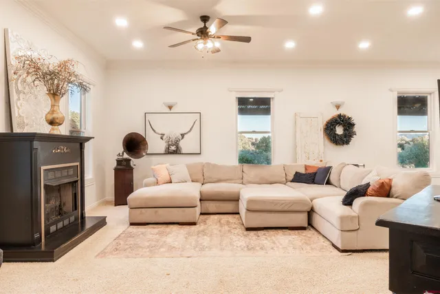 a living room with furniture a fireplace and a flat screen tv