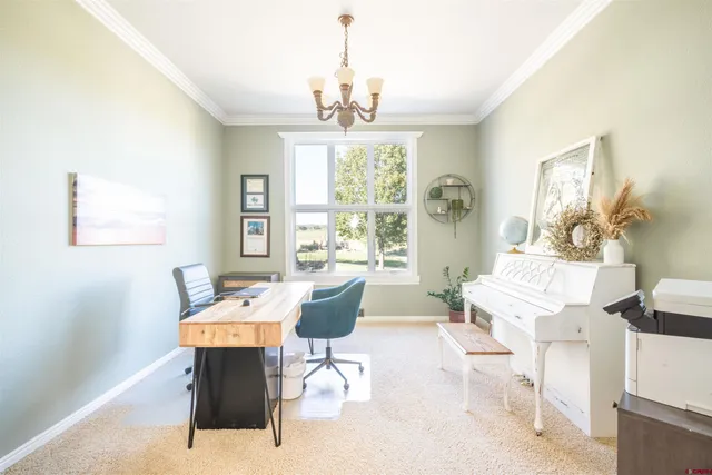 a dining room with wooden floor a chandelier a wooden table and chairs