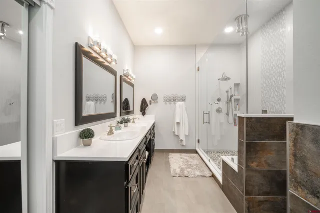 a bathroom with a sink a toilet and shower