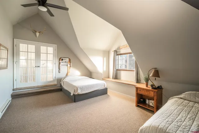 a living room with a bed furniture and a window
