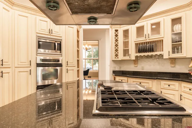 a kitchen with stainless steel appliances granite countertop a stove and a refrigerator