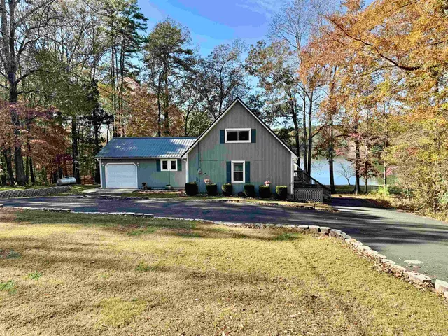 a view of a house with swimming pool and sitting area