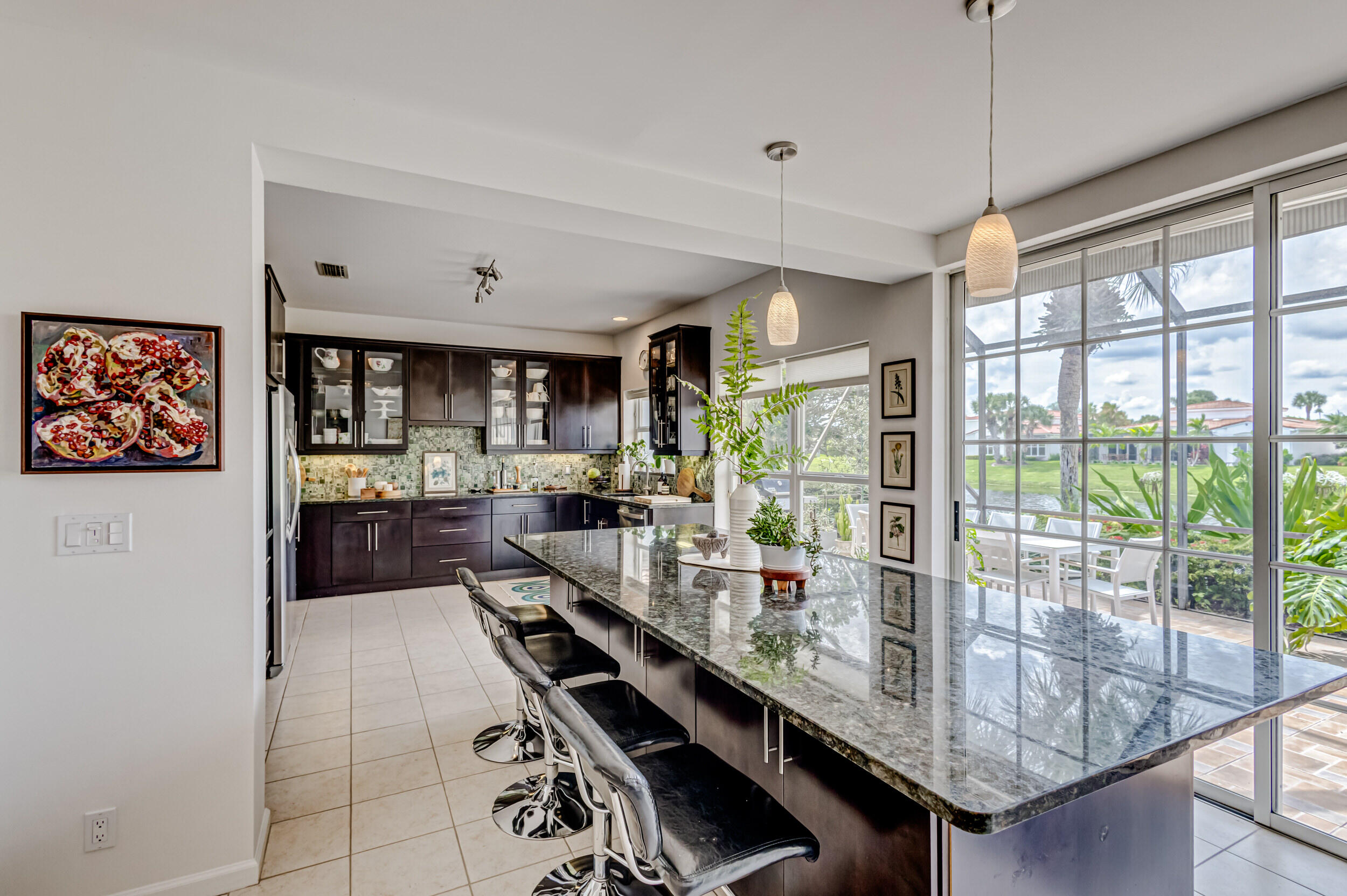 3546 Lantern Bay Drive Jupiter, FL 33477 - Photo 11 of 25 a kitchen with stainless steel appliances granite countertop a stove and refrigerator