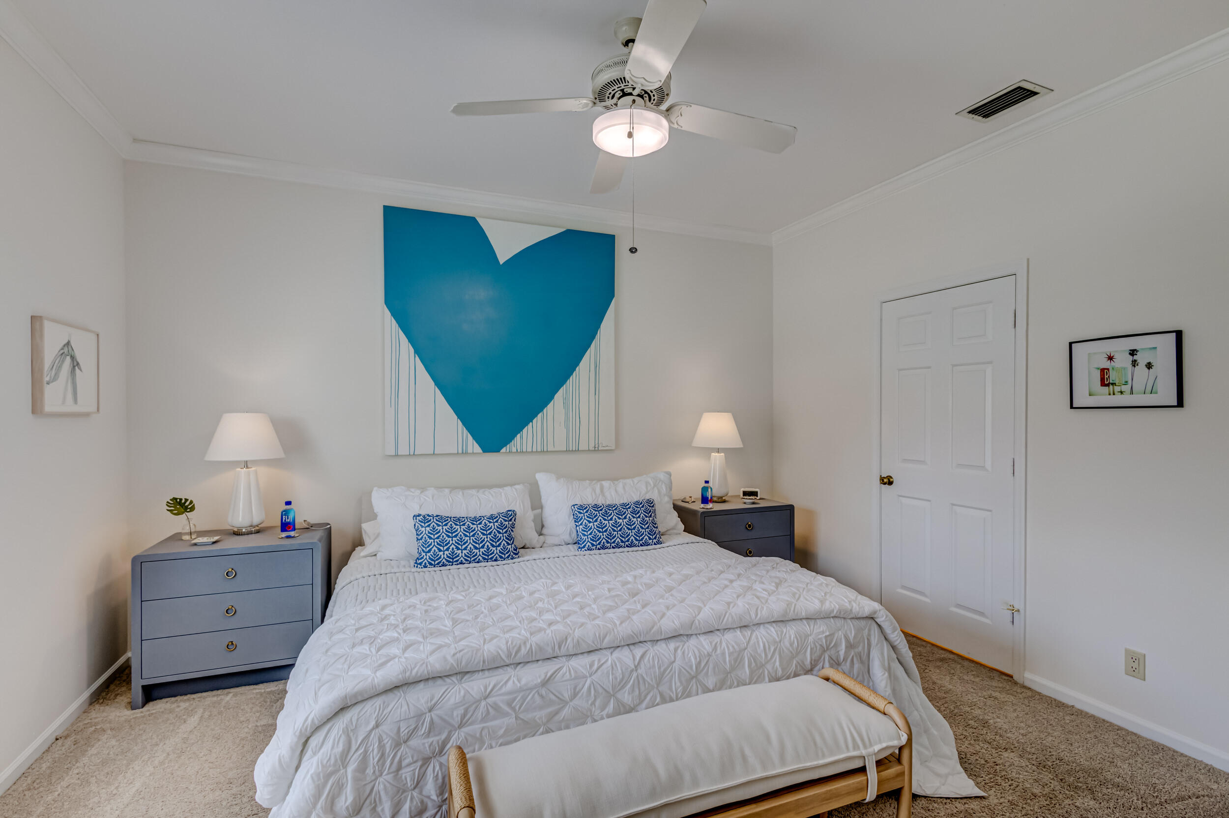 3546 Lantern Bay Drive Jupiter, FL 33477 - Photo 18 of 25 a bedroom with a bed and a painting on the wall